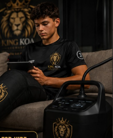 Young athlete using King Koa Recovery compression boots at home